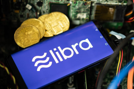 Bangkok, Thailand - July 2, 2019: Phone shows Libra logo on the screen. Facebook reported to utilize...
