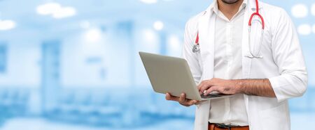 Doctor using laptop computer at the hospital. Medical healthcare and doctor staff service.の写真素材
