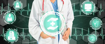 Medical Healthcare Concept - Doctor in hospital with digital medical icons graphic banner showing symbol of medicine, medical care people, emergency service network, doctor data of patient health.の写真素材