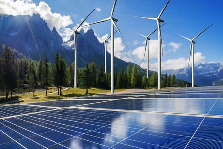 Solar energy panel photovoltaic cell and wind turbine farm power generator in nature landscape for production of renewable green energy is friendly industry. Clean sustainable development concept.の写真素材
