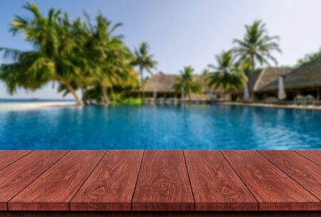 Brown wood table in summer seaside resort with empty copy space on the table for product display mockup. Travel vacation concept.の写真素材