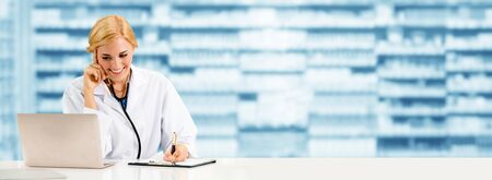 Pharmacist or doctor using laptop computer at the pharmacy room. Medical healthcare and pharmaceutical staff service.の写真素材