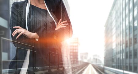 Double Exposure Image of Business Person on modern city background. Future business and communication technology concept. Surreal futuristic cityscape and abstract multiple exposure graphic interface.の写真素材