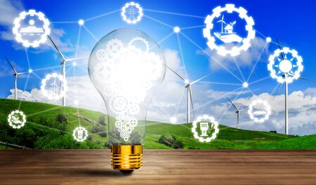 Green energy innovation light bulb with future industry of power generation icon graphic interface. Concept of sustainability development by alternative energy.の写真素材