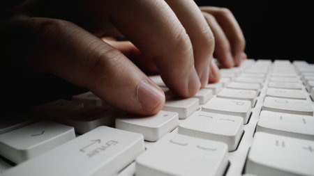 Close-up soft-focus finger typing on keyboard. Man hand using laptop computer in office. Programming...