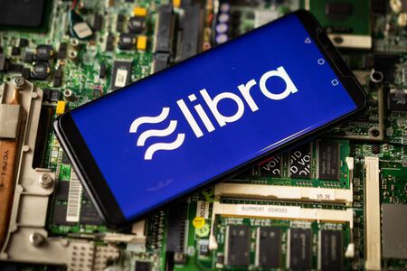 Bangkok, Thailand - July 2, 2019: Phone shows Libra logo on the screen. Facebook reported to utilize new cryptocurrency called Libra. Libra was reported to be used for purchases in Facebook and other.のeditorial素材