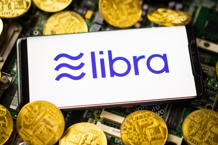 Bangkok, Thailand - July 2, 2019: Phone shows Libra logo on the screen. Facebook reported to utilize...