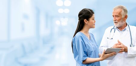 Senior doctor working with young doctor in the hospital. Medical healthcare staff and doctor service.の写真素材
