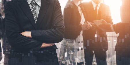Business people group standing together with city office building background double exposure. Modern corporate job and human resources recruiting concept.の写真素材