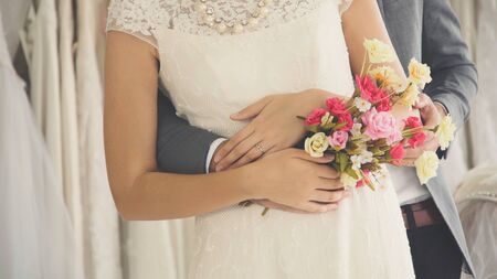Happy bride and groom in wedding dress prepare for married in wedding ceremony. Romantic love of man and woman couple.の写真素材