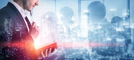 Double Exposure Image of Business Person on modern city background. Future business and communication technology concept. Surreal futuristic cityscape and abstract multiple exposure graphic interface.の写真素材