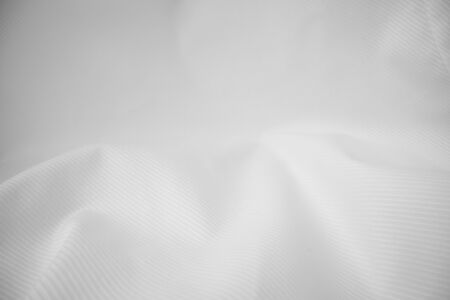Shiny flowing cloth texture in macro shot. Wavy clean silk weave material. Textile abstract background.の写真素材