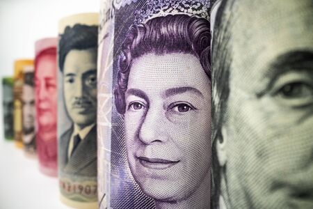 Macro shot of international currency money include US American Dollar, Euro Currency, British UK Pound, Australian Dollar, China Yuan and Japan Yen. Foreign currency money exchange and Forex concept.の写真素材