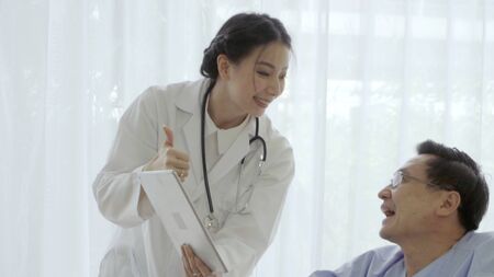 Doctor or physician take care of sick patient at the hospital or medical clinic. The happy patient visit doctor and discuss for illness cure treatment. Medical healthcare and doctor service concept.の写真素材