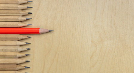 Different pencil standout from the others showing concept of unique business thinking different from...