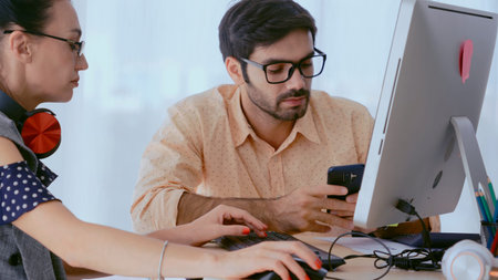 Creative business people group having conversation at office desk in modern workplace. Corporate...