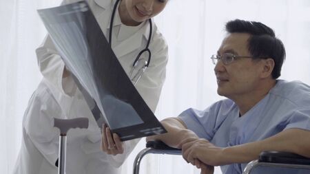 Doctor or physician take care of sick patient at the hospital or medical clinic. The happy patient visit doctor and discuss for illness cure treatment. Medical healthcare and doctor service concept.の写真素材