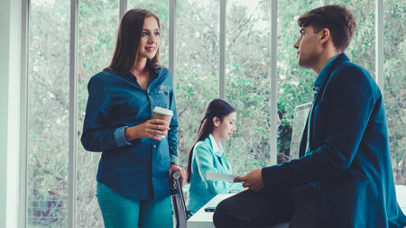 Happy businesswoman and businessman having conversation in modern office. Business corporate and...