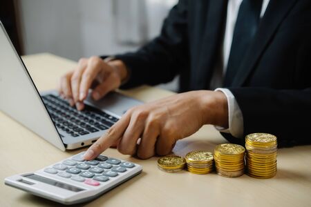 Businessman accountant or financial expert analyze business report graph and finance chart at corporate office. Concept of finance economy, banking business and stock market research.の写真素材