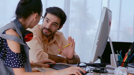 Creative business people group having conversation at office desk in modern workplace. Corporate international business concept.の写真素材