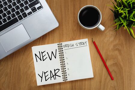 New Year Resolution Goal List 2020 - Business office desk with notebook written in handwriting about plan listing of new year goals and resolutions setting. Change and determination concept.の写真素材