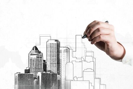 City civil planning and real estate development - Architect people looking at abstract city sketch drawing to design creative future city building. Architecture dream and ambition concept.の写真素材
