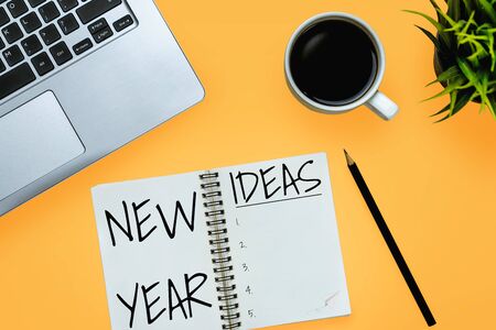 New Year Resolution Goal List 2020 - Business office desk with notebook written in handwriting about plan listing of new year goals and resolutions setting. Change and determination concept.の写真素材