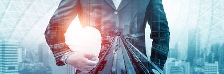 Future building construction engineering project concept with double exposure graphic design. Building engineer, architect people or construction worker working with modern civil equipment technology.の写真素材