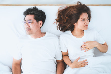 Unhappy Asian senior couple in bedroom. Retirement and bad relationship elderly concept.