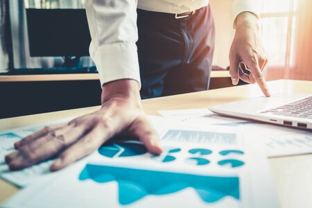 Businessman accountant or financial expert analyze business report graph and finance chart at corporate office. Concept of finance economy, banking business and stock market research.の写真素材