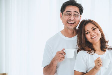 Happy Asian senior couple having good time at home. Old people retirement and healthy citizens elderly concept.の写真素材