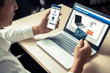 Young man use credit card for shopping payment online on laptop computer application or website....