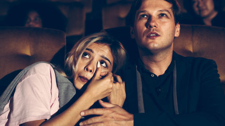 People audience watching movie in the movie theater cinema. Group recreation activity and...