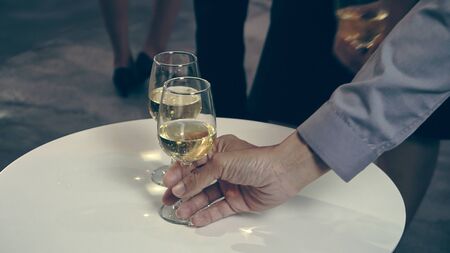 Successful business people drink wine and champagne with team members in ball room to celebrate business project to launch new product to market. Corporate business and people networking concept.の写真素材