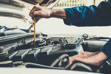 Professional mechanic providing car repair and maintenance service in auto garage. Car service business concept.の写真素材