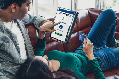 Young couple use credit card for online shopping on internet website at home. Number on the credit...