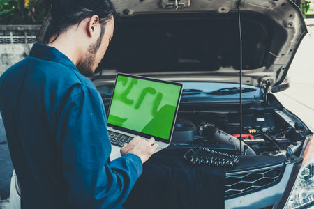 Professional mechanic providing car repair and maintenance service in auto garage. Car service...