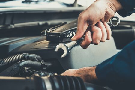 Professional mechanic providing car repair and maintenance service in auto garage. Car service business concept.の写真素材