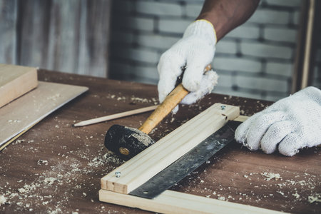 Carpenter working on wood craft at workshop to produce construction material or wooden furniture....