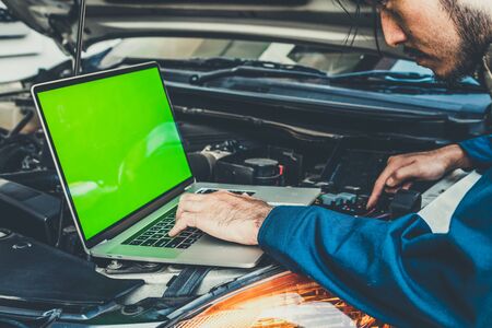 Professional mechanic providing car repair and maintenance service in auto garage. Car service business concept.の写真素材