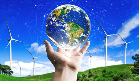 Concept of sustainability development by alternative energy. Man hand take care of planet earth with...