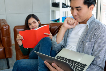 Happy Asian couple relax in living room. Love and relationship concept.