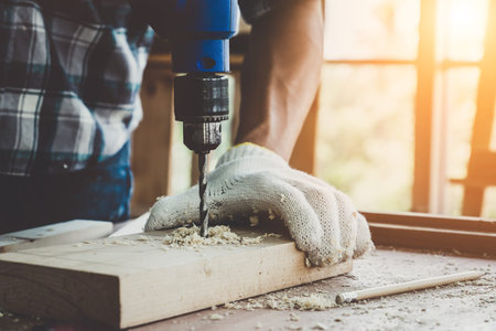Carpenter working on wood craft at workshop to produce construction material or wooden furniture....