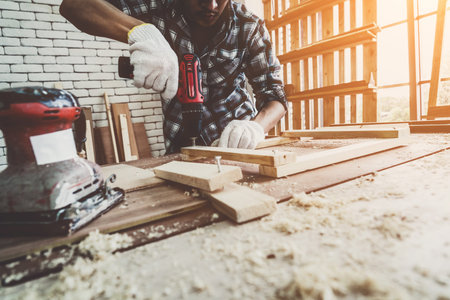 Carpenter working on wood craft at workshop to produce construction material or wooden furniture....