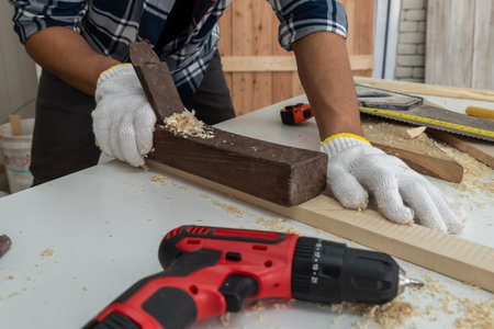 Carpenter working on wood craft at workshop to produce construction material or wooden furniture....