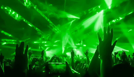 Happy people dance in nightclub DJ party concert and listen to electronic dancing music from DJ on...