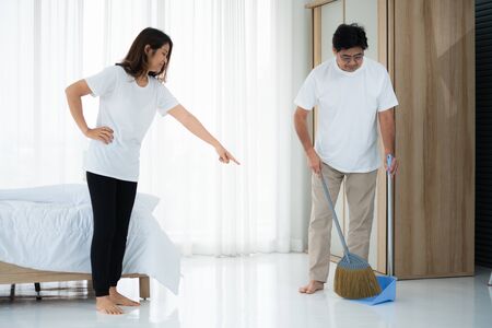 Asian senior couple cleaning bedroom floor. Retirement and healthy elderly concept.の写真素材