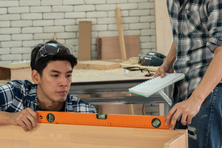 Carpenter working on wood craft at workshop to produce construction material or wooden furniture....