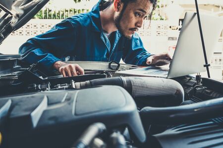 Professional mechanic providing car repair and maintenance service in auto garage. Car service business concept.の写真素材