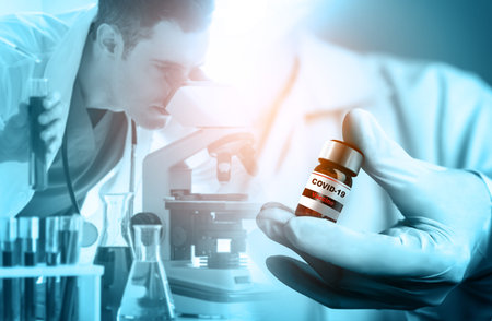 Coronavirus COVID-19 medical test vaccine research and development concept. Scientist in laboratory...